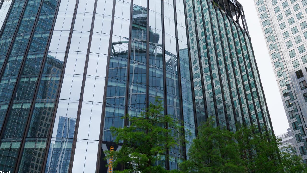 Glass and steel high-rise under a low sky, representing modern civil engineering construction